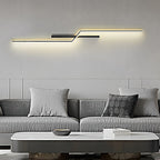 Linear wall sconce mounted horizontally above a sofa