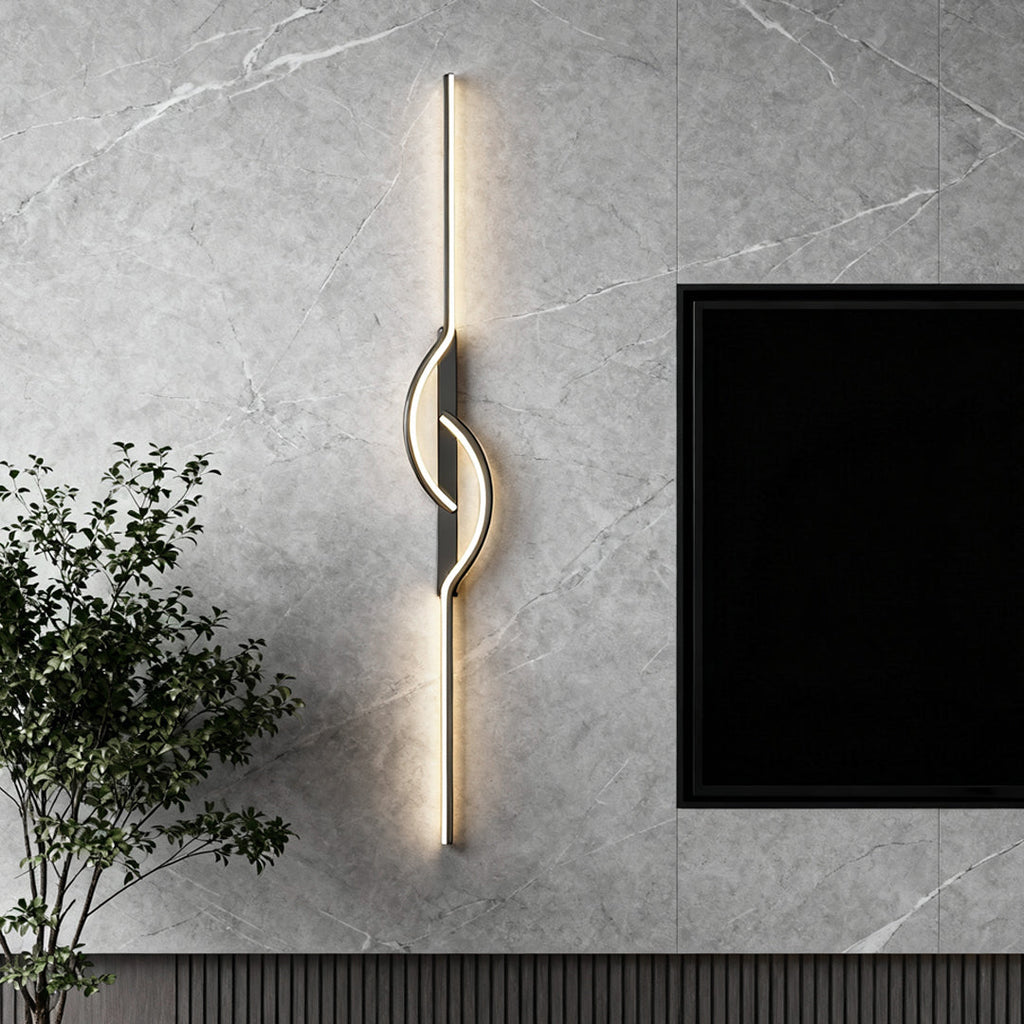 Black linear wall sconce mounted on a textured gray wall