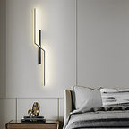 Linear wall sconce mounted vertically in a bedroom
