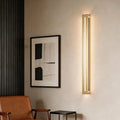 Long black linear wall sconce in a modern living room