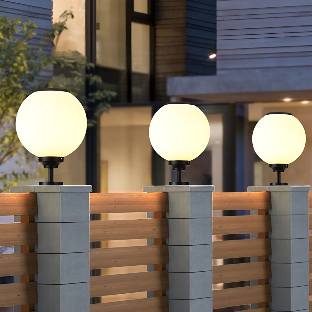 Minimalist spherical pillar light mounted on a stone pillar