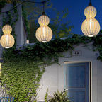Rattan pendant light hanging beside an exterior wall