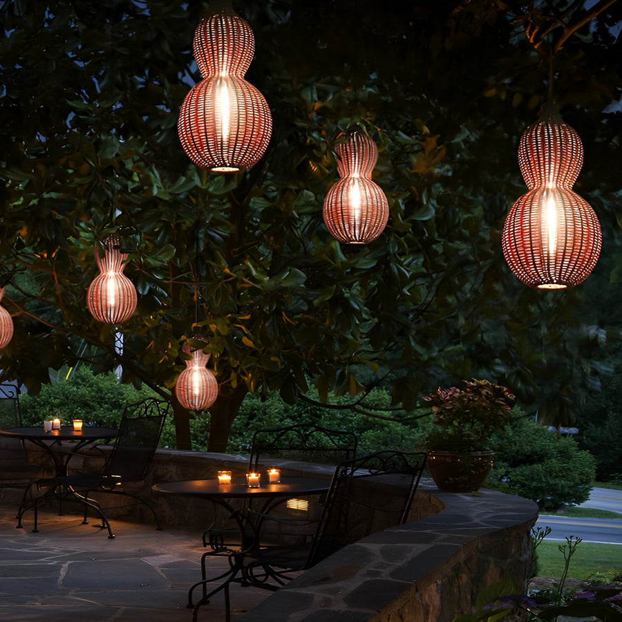 Woven rattan pendant light hung from a tree branch