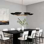 Six-light disc shade chandelier above a long black table