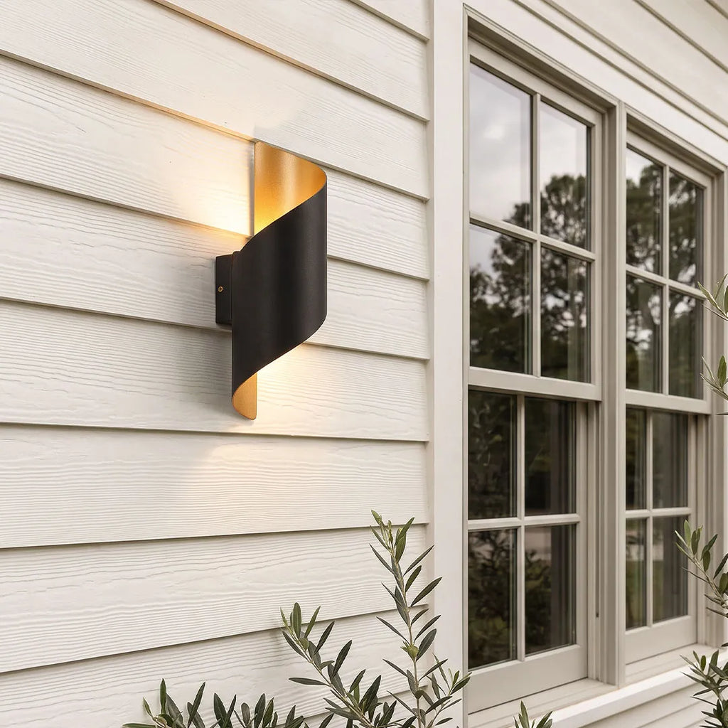 Black and gold spiral wall light on an exterior wall