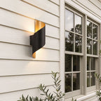 Black and gold spiral wall light on an exterior wall