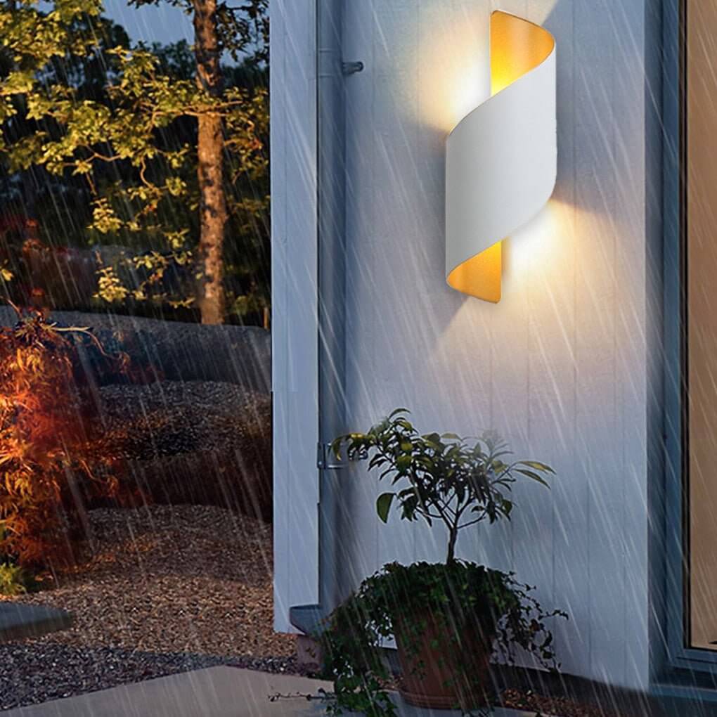 Spiral LED wall sconce dimmed low in a bedroom