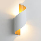 Spiral LED wall light lighting an indoor staircase