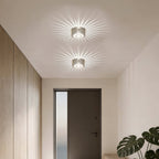 Sunburst ceiling light casting a warm radiant glow in a hallway