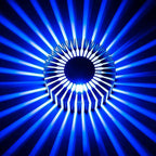 Sunburst ceiling light glowing vibrant blue in a living space