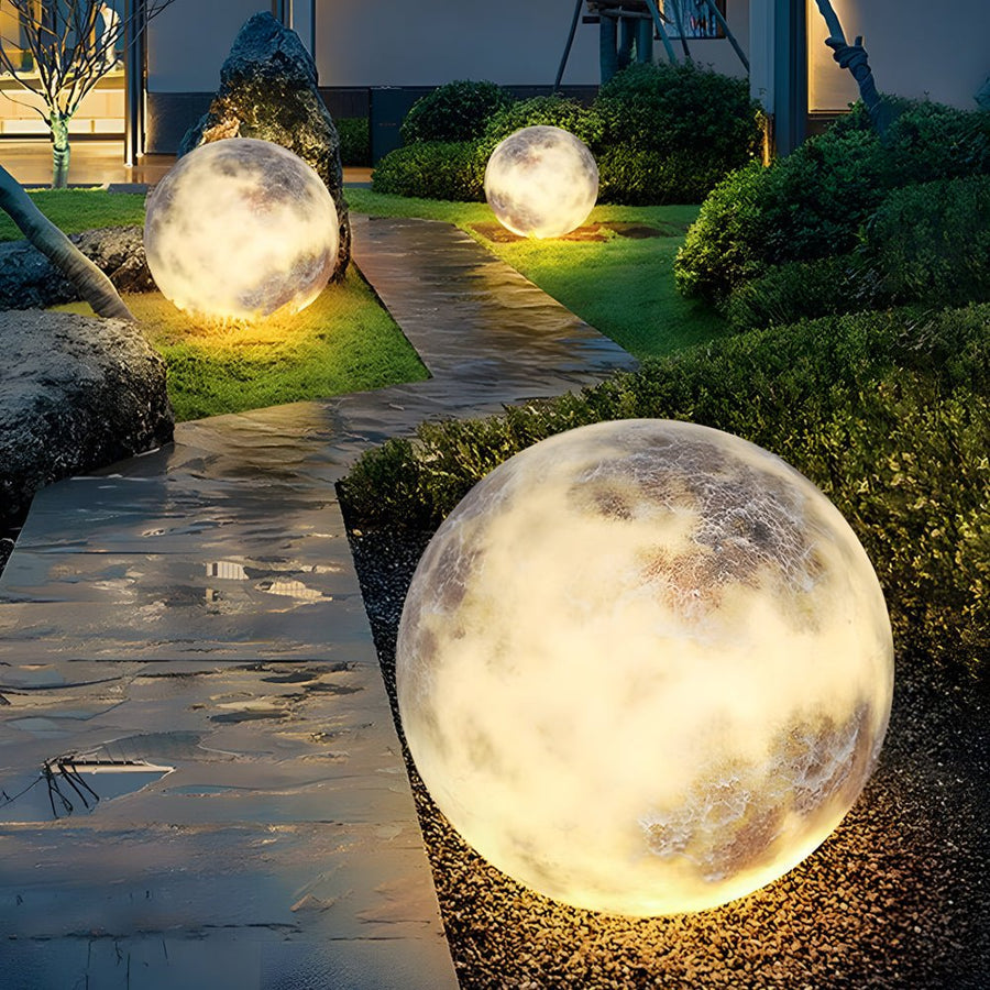Moon globe lights lining an outdoor pathway walkway
