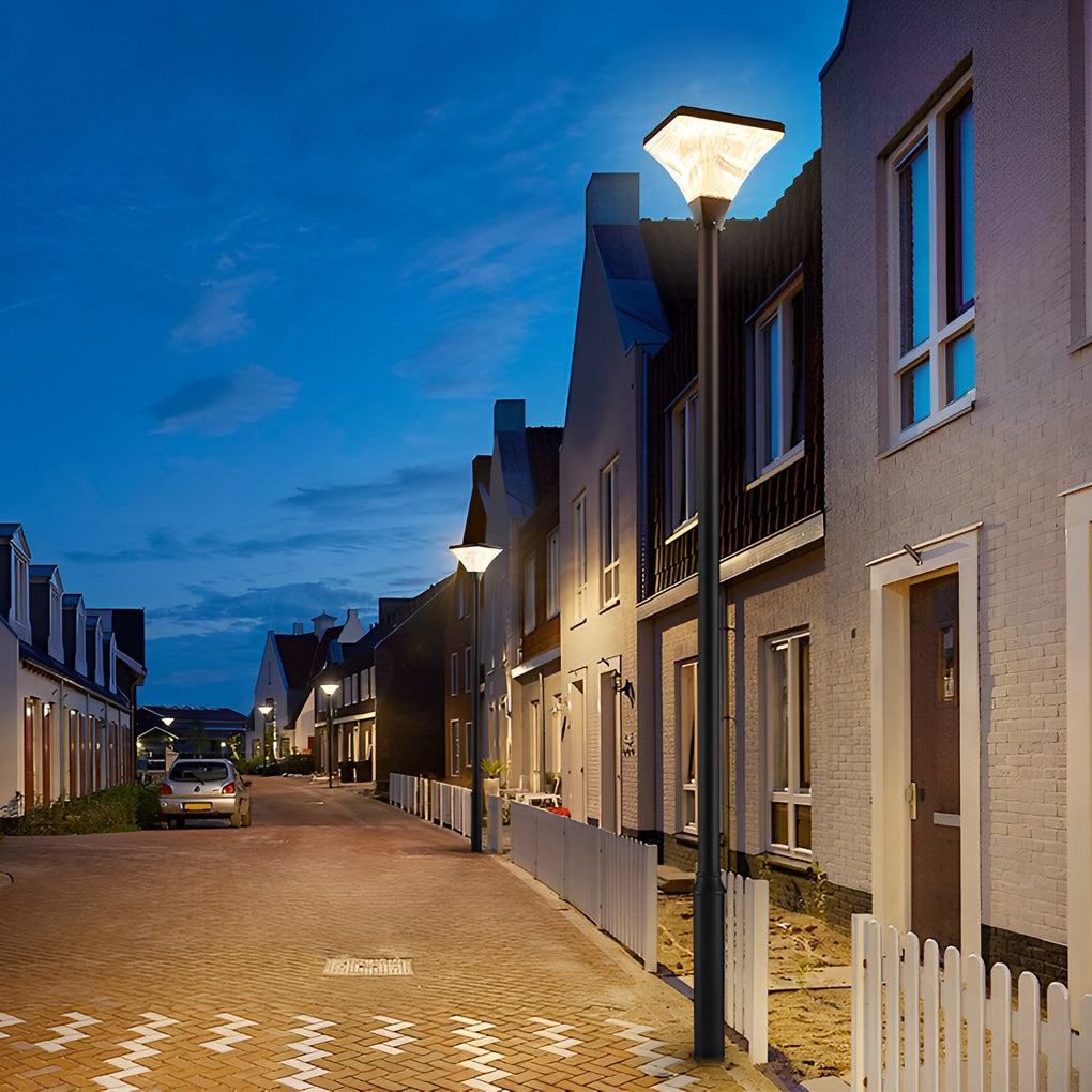 Street light standing in front of residential townhouses after dark