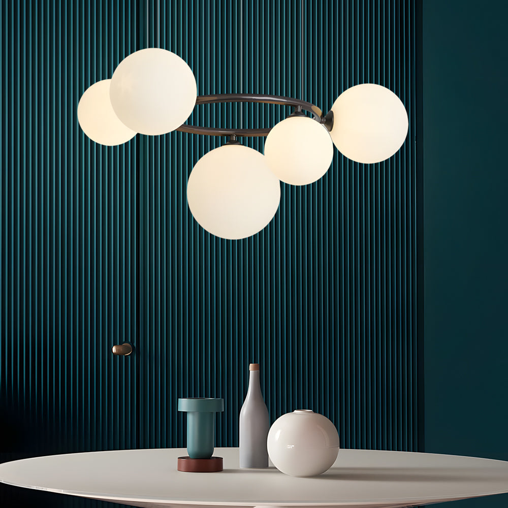 Copper-finish globe chandelier casting ambient light in a stylish room