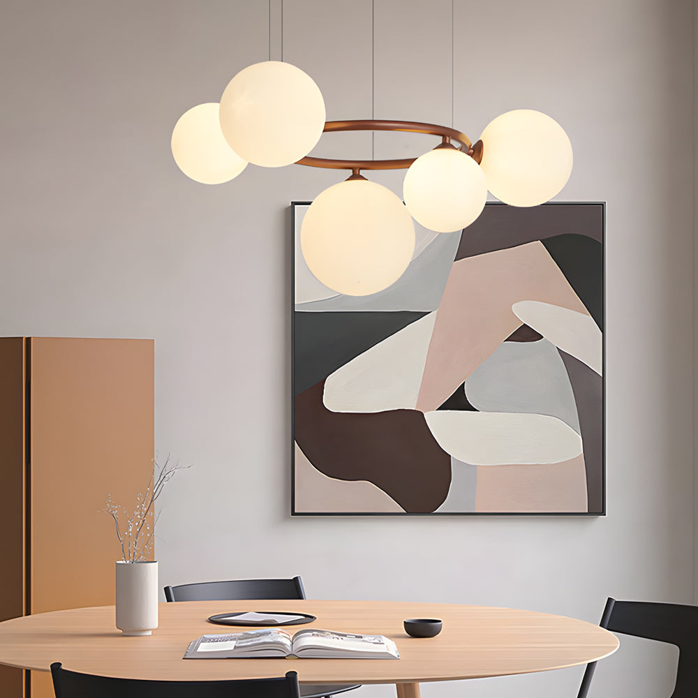 Globe chandelier hanging over a sleek contemporary dining table