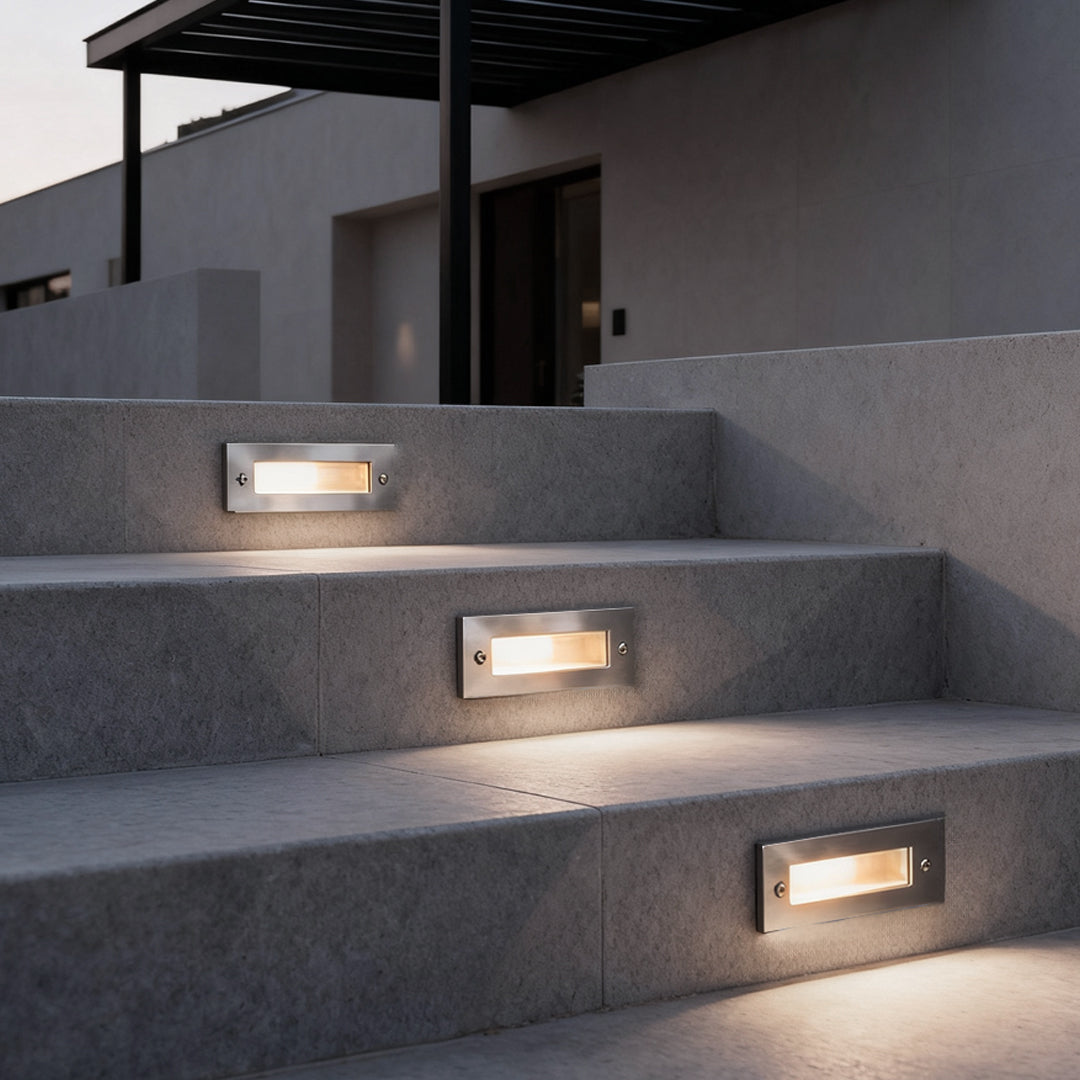 Recessed brick light set into modern stone stairs