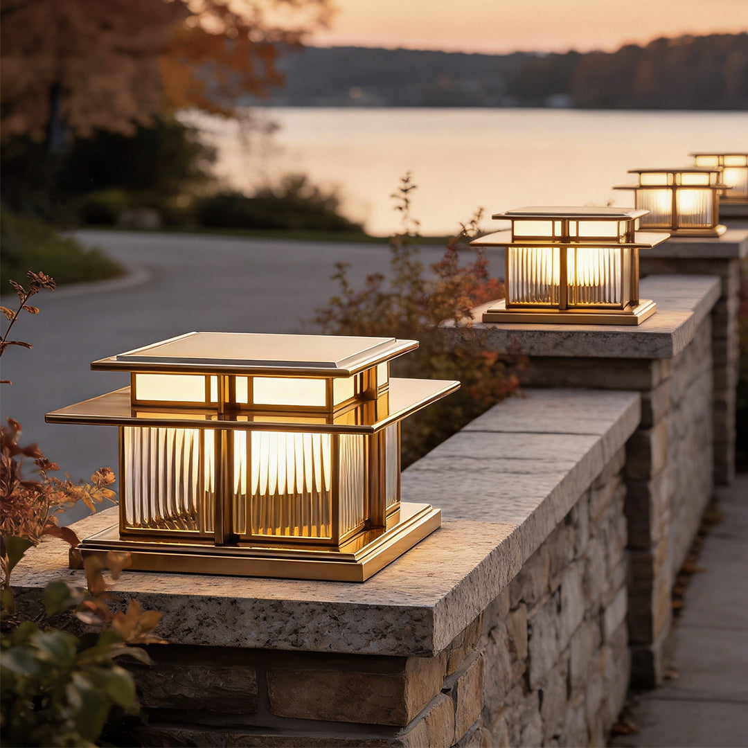 Pillar lights on a stone fence beside a pathway