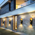 Cylinder up-down sconce on a stone facade of a contemporary building