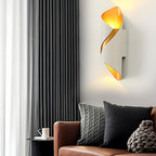 White and gold cylinder sconce in a cozy indoor setting