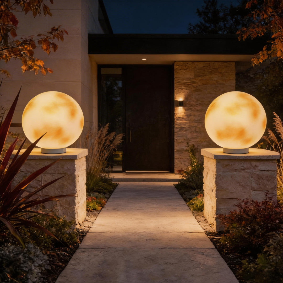 Pair of moon globe pillar lights at a modern home entrance