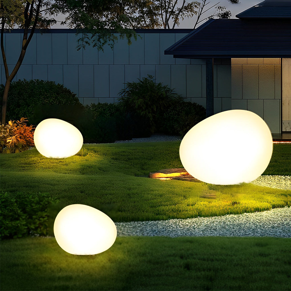 Stone-shaped pebble lights casting ambient glow on outdoor steps