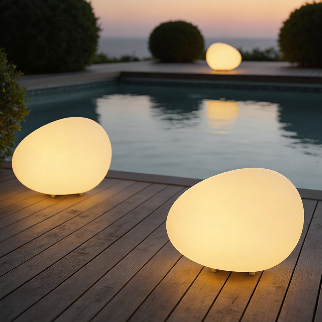 Pebble lights giving warm light in a modern pool area