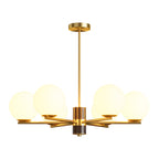 Polished brass chandelier with opal glass spheres