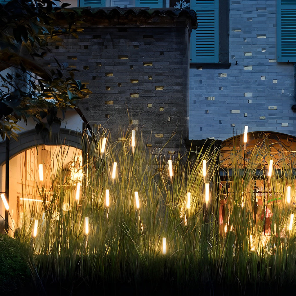 Reed lights casting ambient glow beside a stone wall