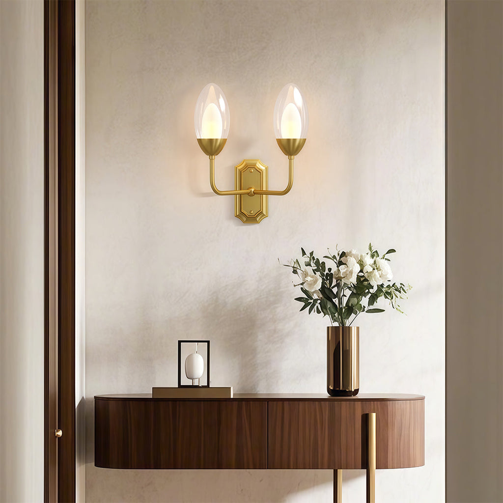 Glass wall light above a console with a candle-like glow