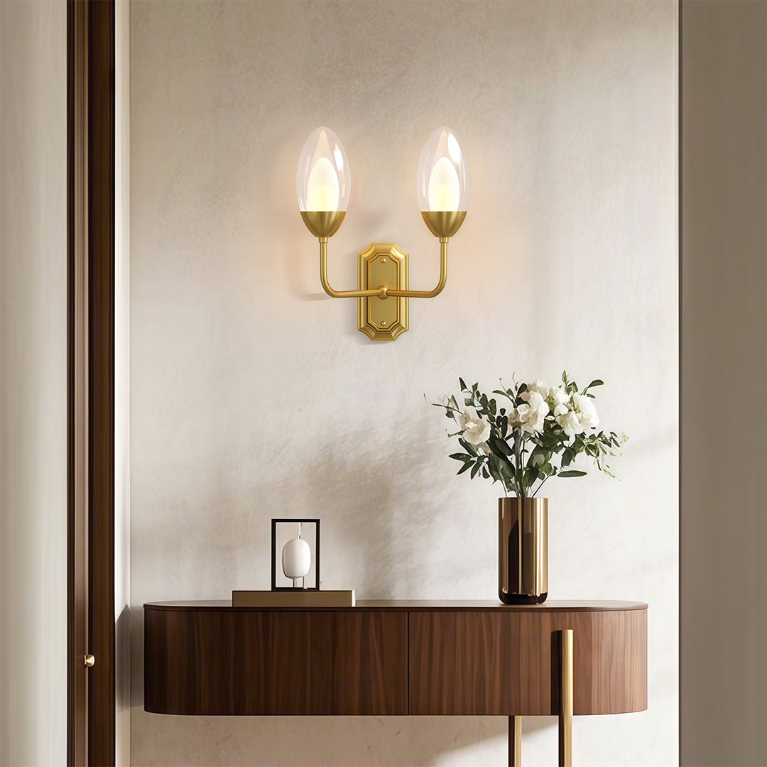 Glass wall light above a console with a candle-like glow