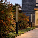 Bollard light shown installed beside a garden walkway