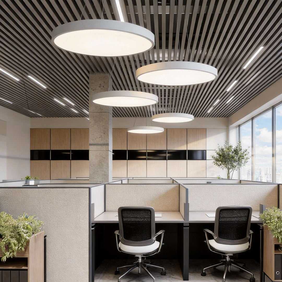 Round pendant lights over a cubicle office floor