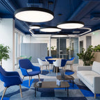 Round pendant lights above an office lounge area