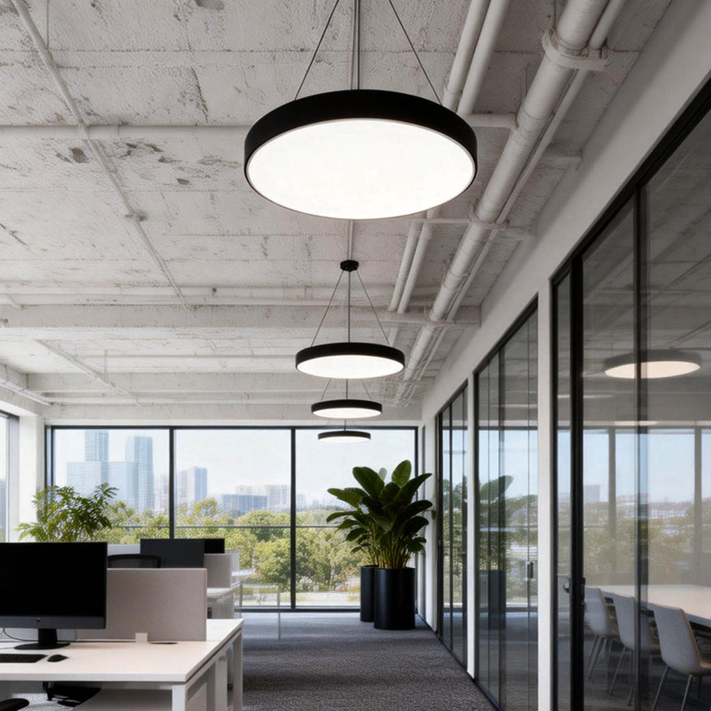 Round pendant lights mounted on an open office ceiling