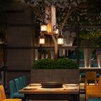 Rustic wood lantern chandelier lighting a restaurant interior