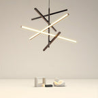 Sculptural angular branch chandelier hanging above a grey sofa