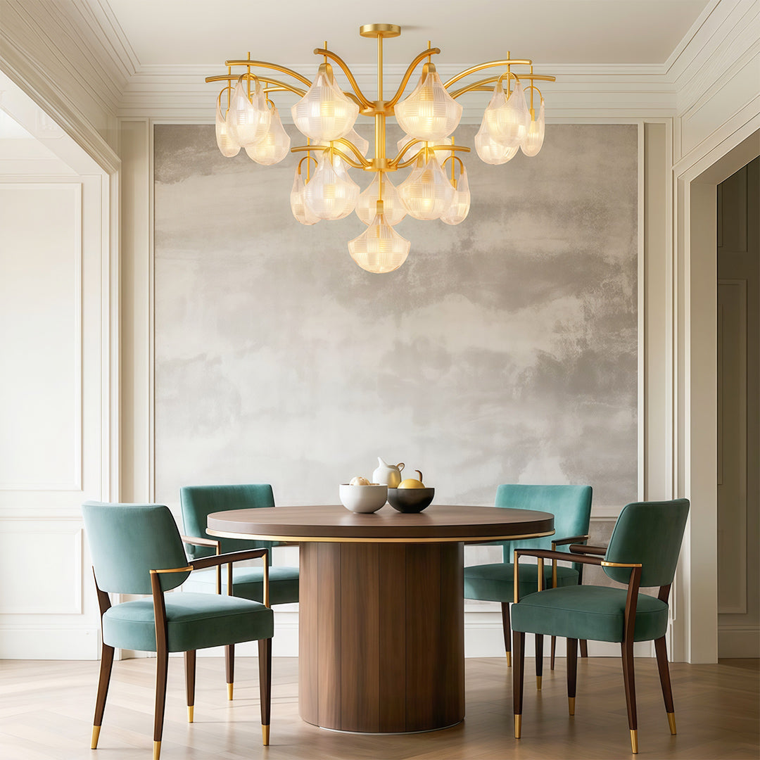 Shell chandelier above a round dining table with teal chairs