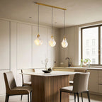 Shell chandelier over a dining table with upholstered chairs