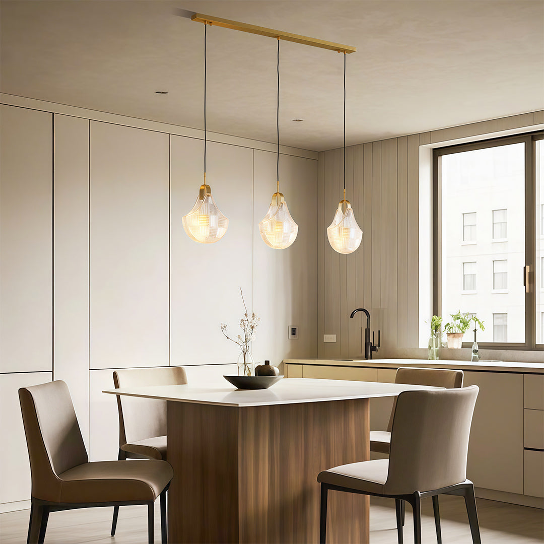 Shell chandelier over a dining table with upholstered chairs