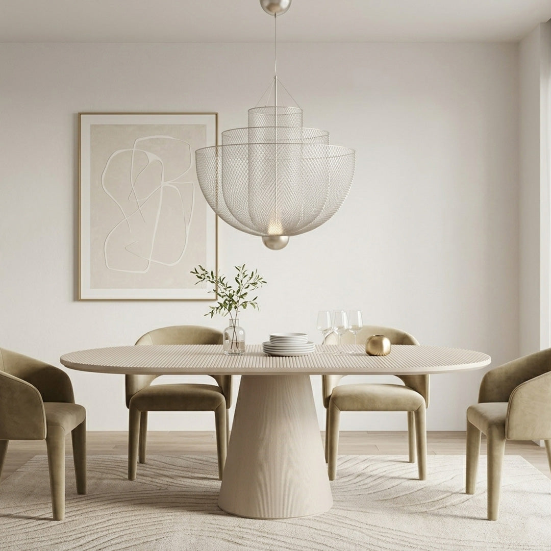 Silver mesh tiered chandelier over a cream oval dining table