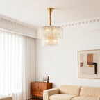 Small chandelier in a serene beige bedroom with sheer curtains