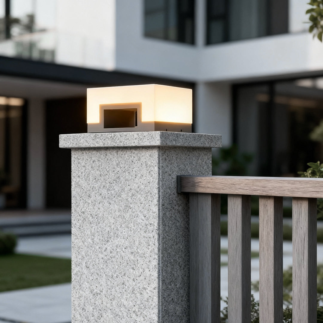 Square solar post light on a concrete fence pillar