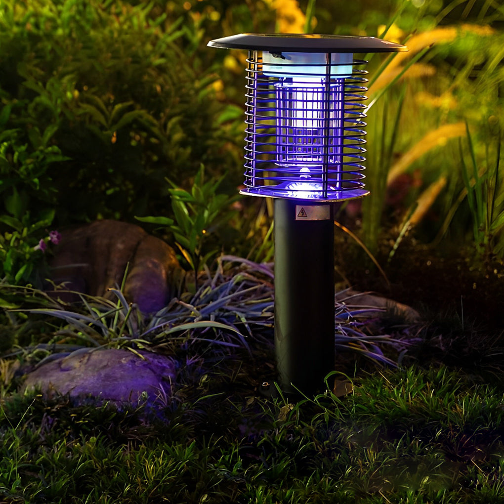 Bug zapper glowing with UV light in a garden at night