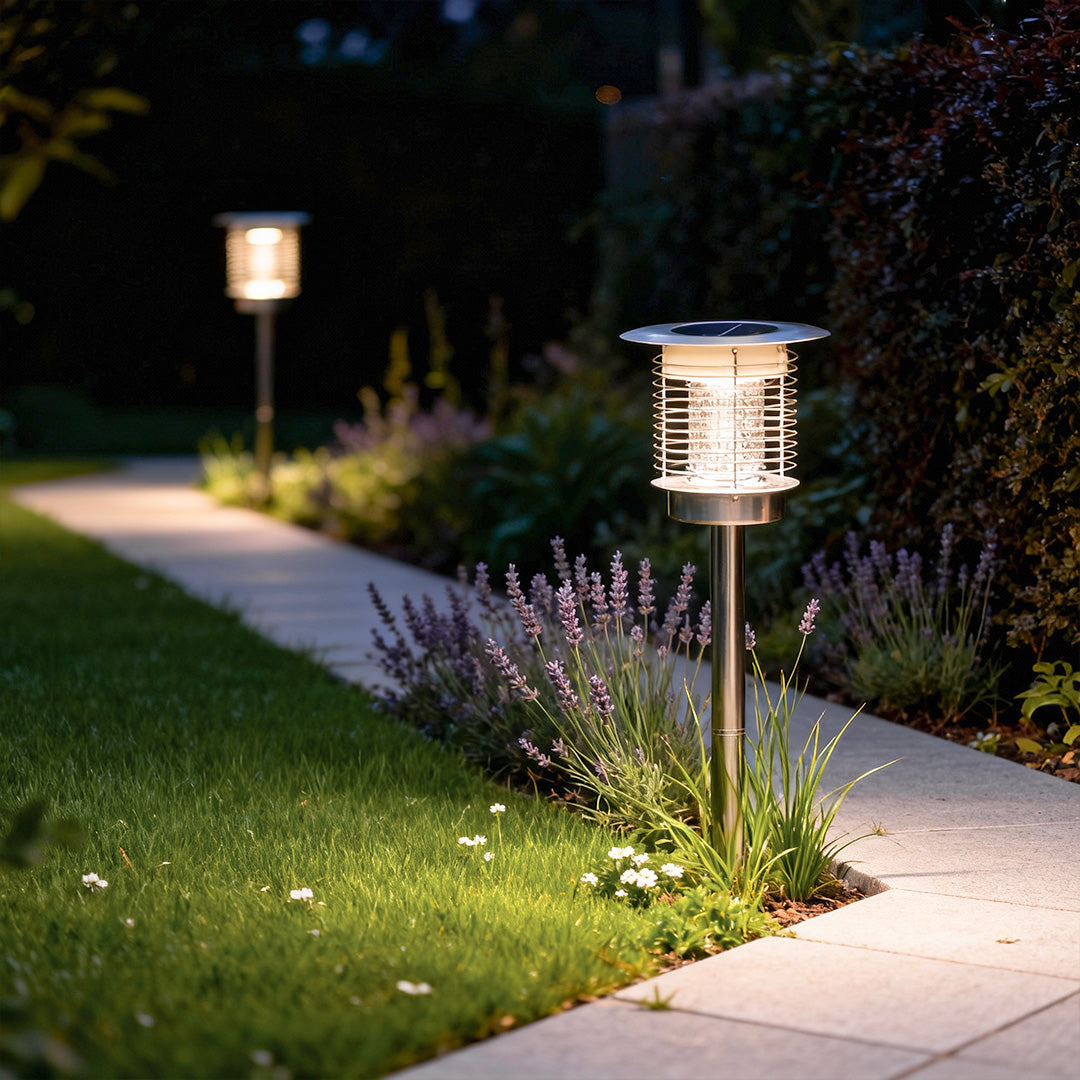 Solar bug zapper light beside a garden walkway