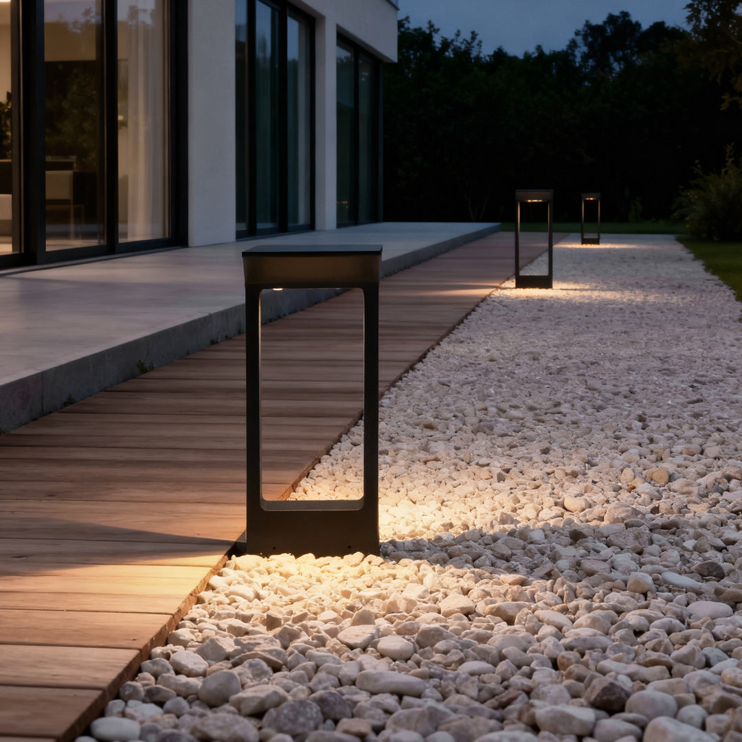 Solar pathway light beside a gravel path near a deck