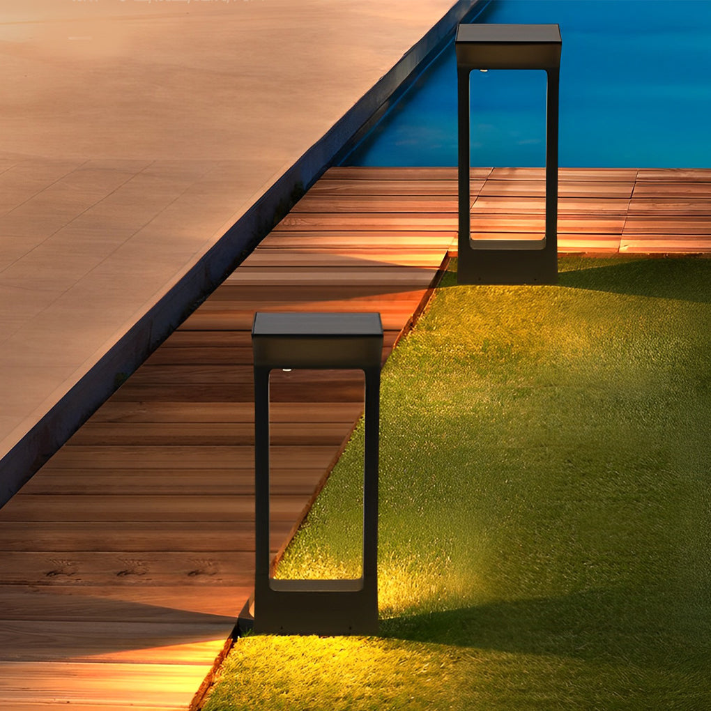 Solar pathway lights on a lawn beside a pool