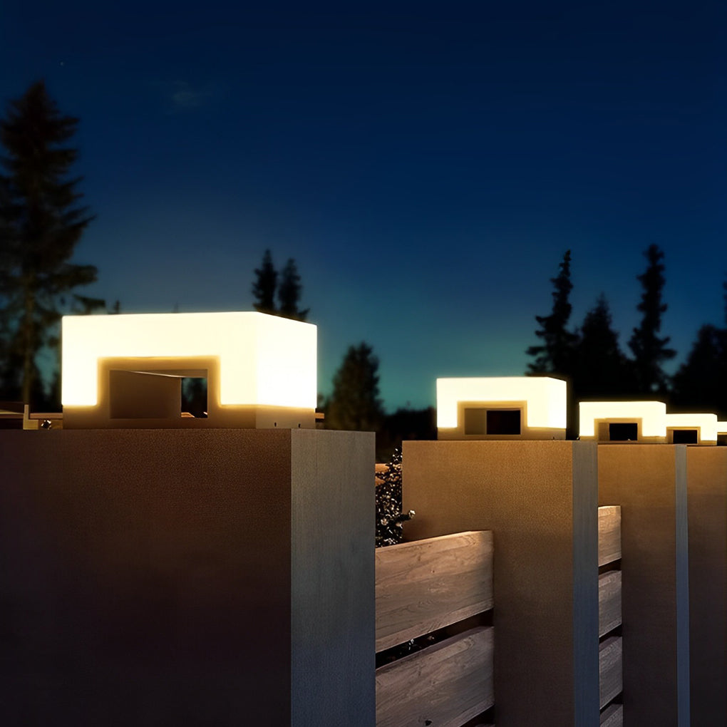 Solar powered post lights capping a row of fence posts