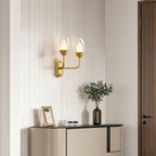 Glass wall light giving warm ambient light in an entryway