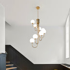 Gold spiral globe chandelier hanging in a stairwell
