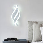 Spiral sconce giving a gentle glow in a minimalist bedroom
