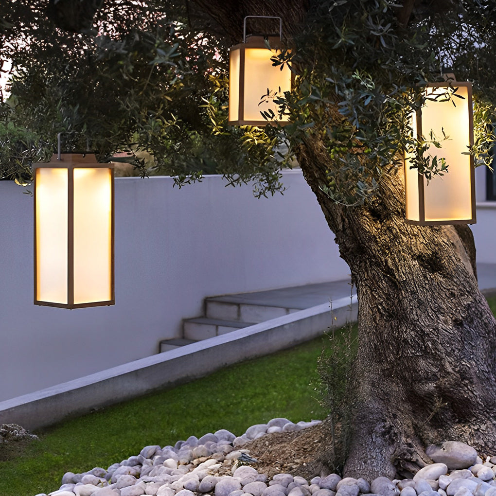 Square lantern on a garden pathway with decorative pebbles